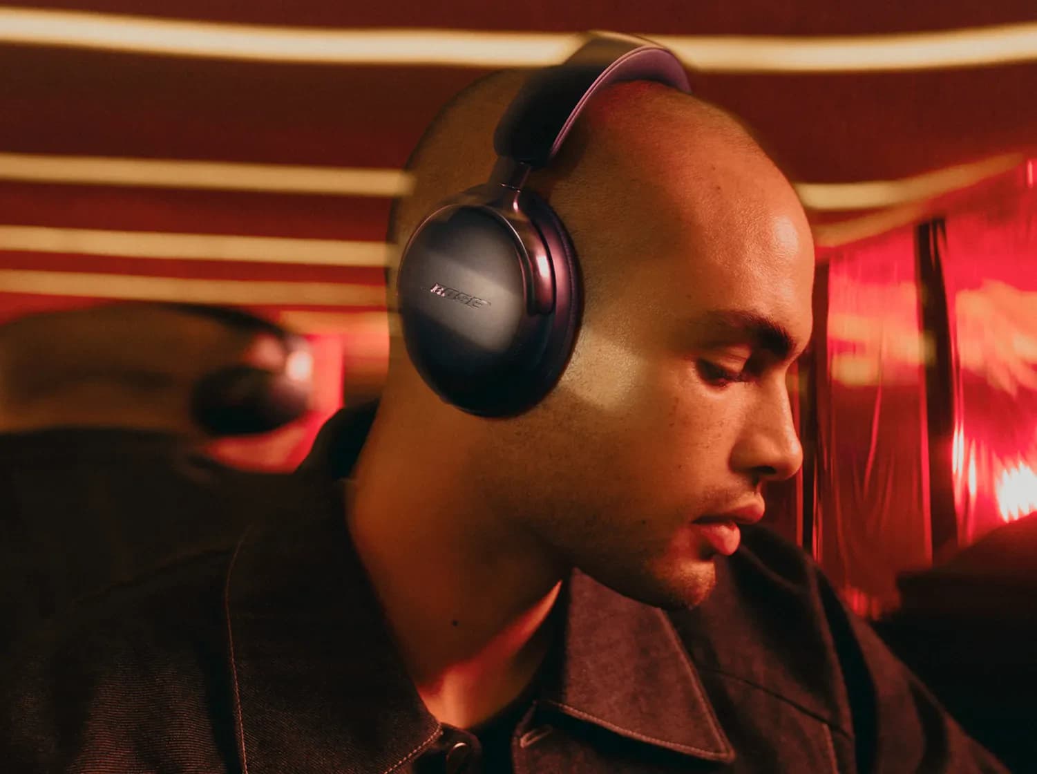 A man wearing Bose QuietComfort Ultra Headphones (2nd Gen) in black