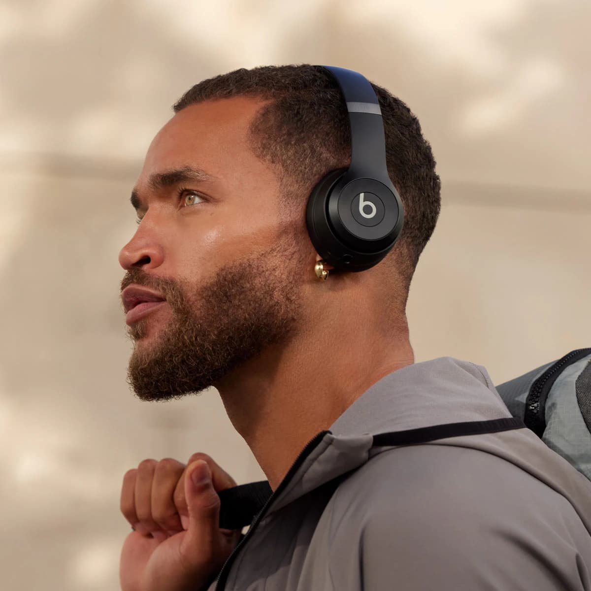 A man wearing Beats Solo 4 headphones in matte black